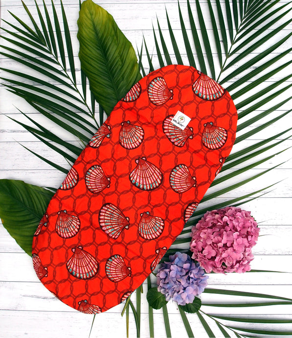MILIKAI CO 100% cotton bassinet liner handmade from traditional African ankara fabric. Red sea shell variant. Three layers of inner cotton wadding for extra comfort. Made to complement the MILIKAI CO Pilot stroller. Length 70.5 centimetres, width 32 centimetres.